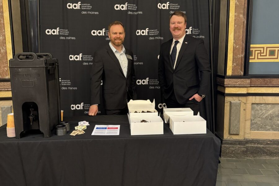 Photo of AAF's booth in the State Capitol Rotunda. AAF's Tom Woody and Nathan White are standing behind the table smiling.
